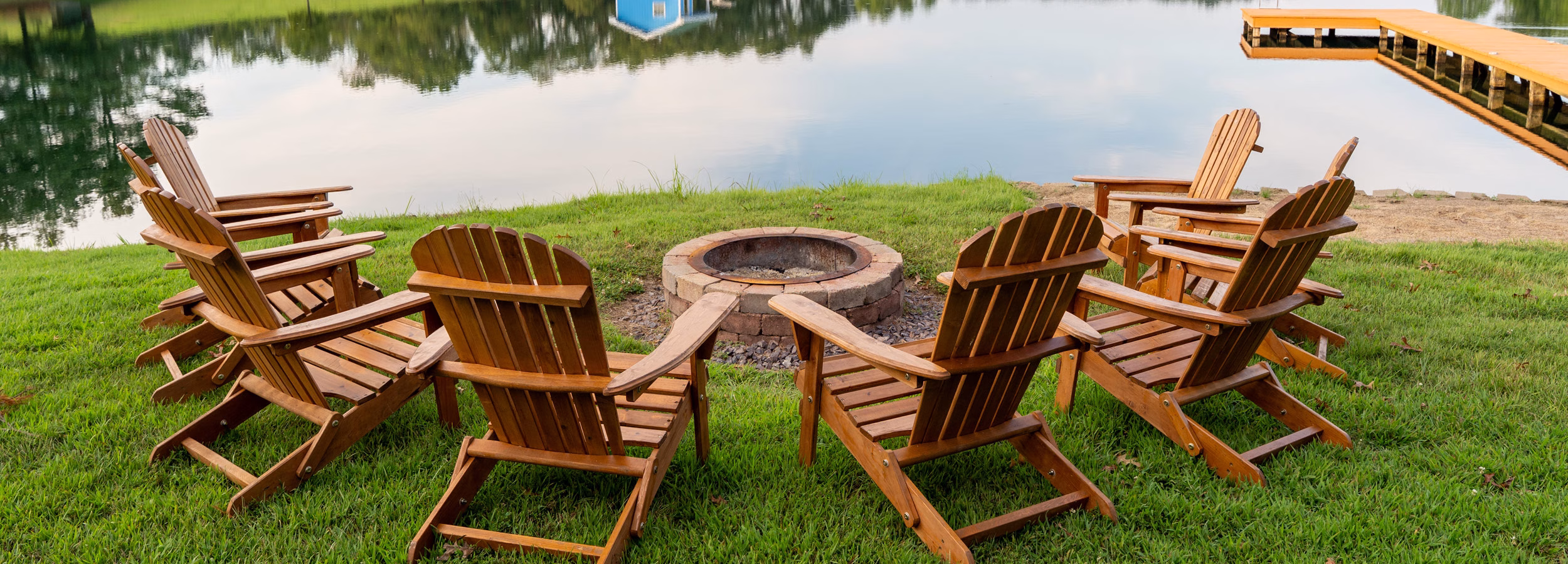 Adirondack chairs around a fire pit at the Indiana Lakeside Cabin